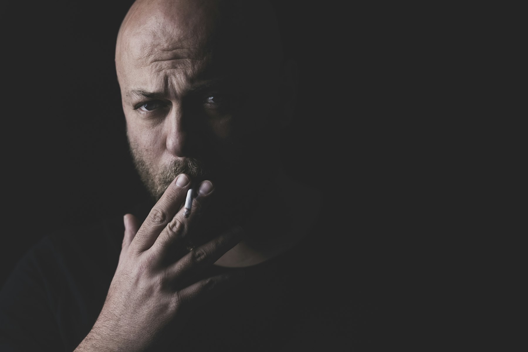 Portrait of a man holding a cigarette